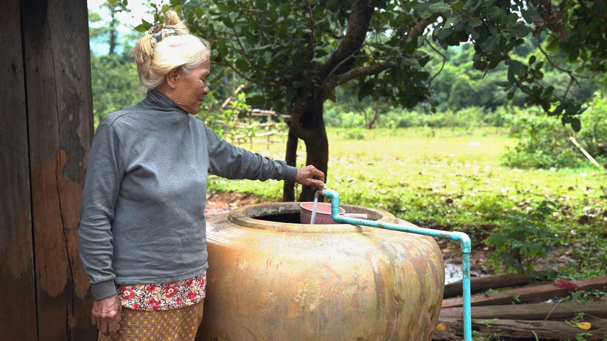 Elderly woman showing her tapper water